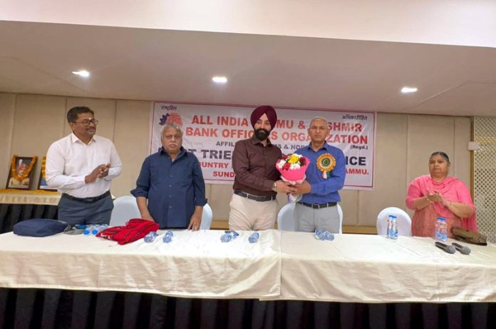 An AIJKBOO dignitary greeting Labour Commissioner, Charandeep Singh, with a flower bouquet in Jammu on Sunday.