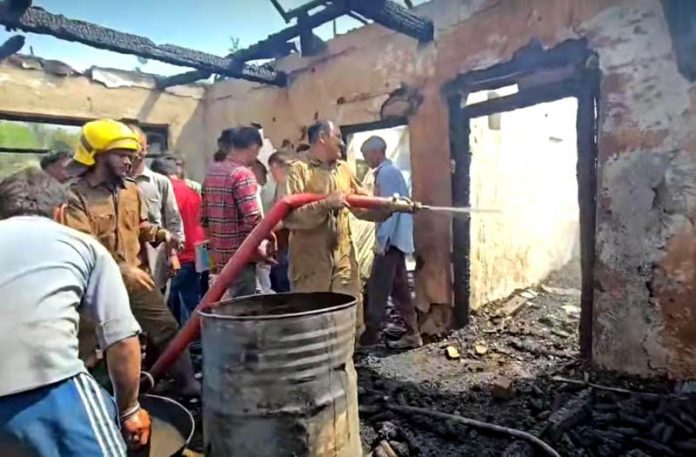 Firemen dousing blaze during fire incident in Chenani. -Excelsior/K Kumar Firemen dousing blaze during fire incident in Chenani. -Excelsior/K Kumar