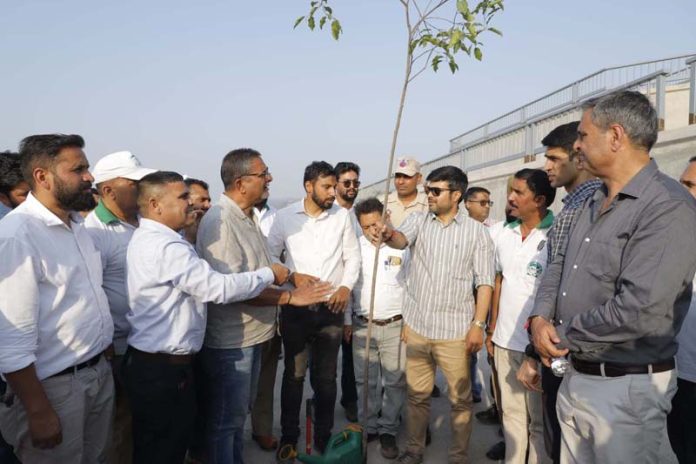 Dr Devansh Yadav interacting with locals after planting a sapling on the left bank of Tawi River on Monday. Dr Devansh Yadav interacting with locals after planting a sapling on the left bank of Tawi River on Monday.