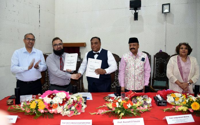 Dignitaries exchanging documents after signing an MoU at Srinagar. Dignitaries exchanging documents after signing an MoU at Srinagar.