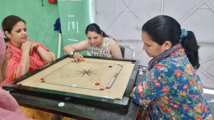 Players keenly taking part in Carrom game at Jammu University.