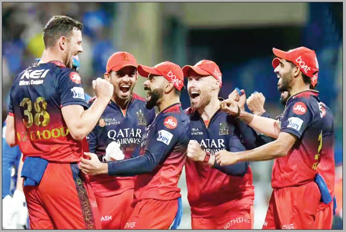 RCB celebrating after defeating MI in a thrilling contest at Mumbai. RCB celebrating after defeating MI in a thrilling contest at Mumbai.