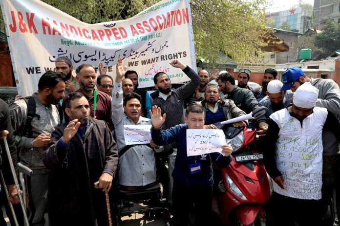 Members of J&K Handicapped Association during a protest at Srinagar on Monday. -Excelsior/Shakeel