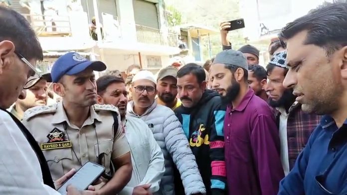 Villagers staging protest over mysterious death of a youth in Darhal area on Sunday. -Excelsior/ Imran