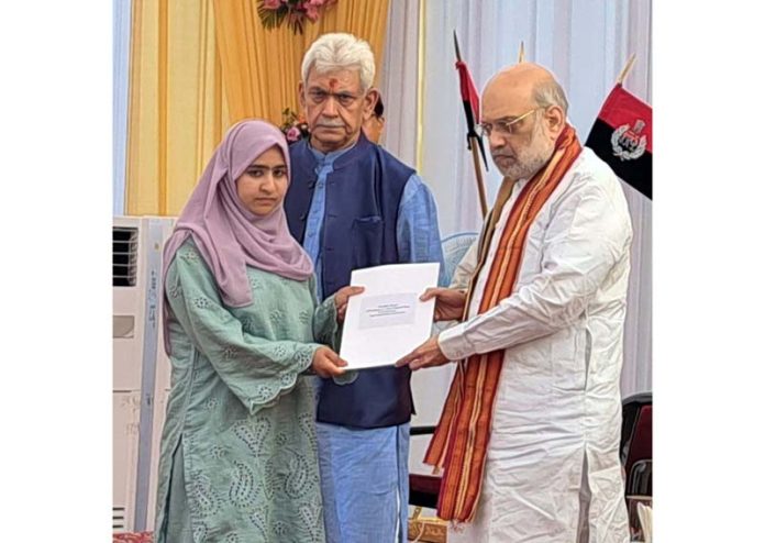 Union Home Minister Amit Shah handing over appointment letter to a girl in Jammu on Monday.