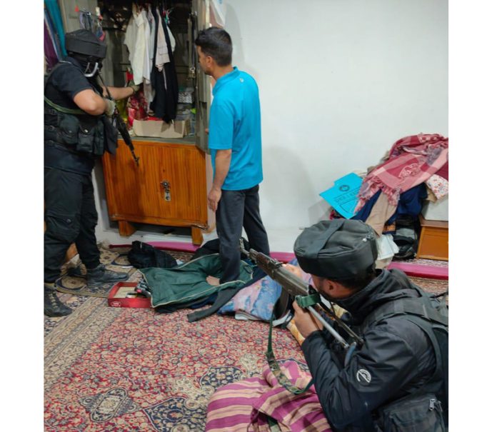 SOG & CRPF personnel during search at the house of an OGW in Pulwama on Friday. — Excelsior/Younis Khaliq SOG & CRPF personnel during search at the house of an OGW in Pulwama on Friday. — Excelsior/Younis Khaliq