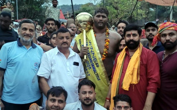 Winner wrestler posing along with dignitaries at Reasi. Winner wrestler posing along with dignitaries at Reasi.