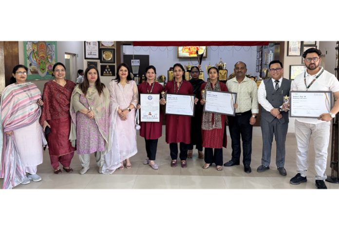 Teachers posing along with school management.