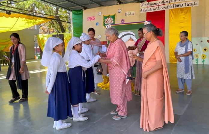 Dignitaries posing along with students during a programme. Dignitaries posing along with students during a programme.
