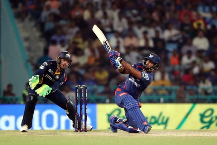 Nicholas Pooran playing a sweep shot during his inning of 61 runs against Gujarat Titans at Lucknow on Saturday.