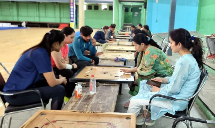 Players displaying keen interest during a carrom tournament at Jammu University. Players displaying keen interest during a carrom tournament at Jammu University.