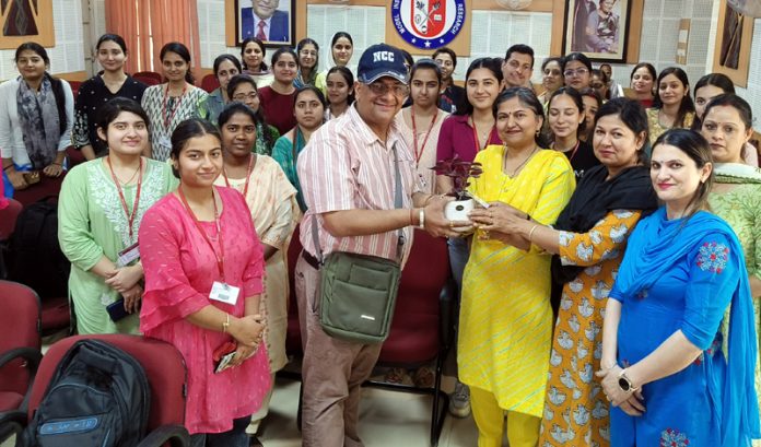 College management presenting plant to a dignitary.