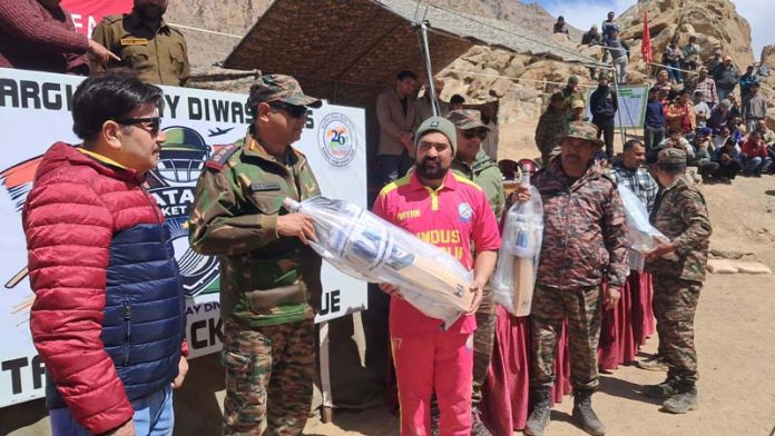An Army officer presenting cricket kit to a player at Batalik during a programme.