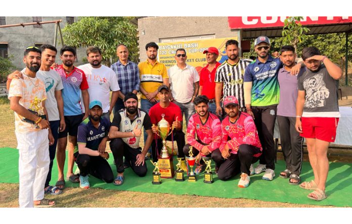 Winning team posing along with trophy and dignitaries.