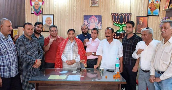 BJP president, Sat Sharma addressing a party meeting at Swaran Vihar on Tuesday.