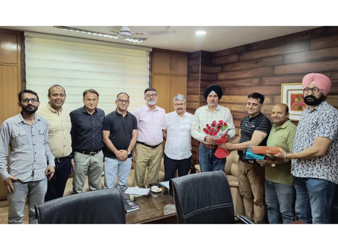 Promotee employees of I&C led by Director Dr Arun Manhas posing with Secretary Vikramjeet Singh.