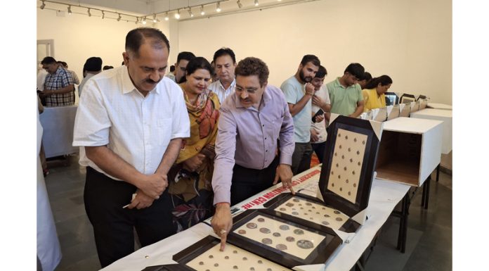 Principal Secretary Culture, Brij Mohan Sharma watching exhibition of rare coins in Jammu.
