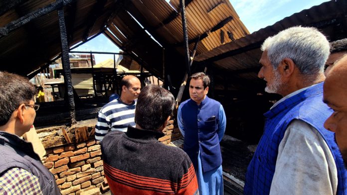 National Conference chief spokesperson, Tanvir Sadiq interacting with Rainawari fire victims in Srinagar on Thursday. National Conference chief spokesperson, Tanvir Sadiq interacting with Rainawari fire victims in Srinagar on Thursday.
