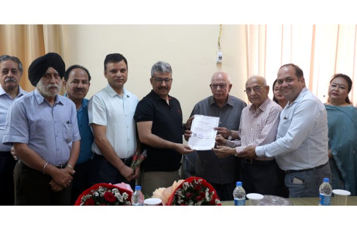 Director Industries Jammu, Arun Manhas giving Registration Certificate to office bearers of Mahajan Sabha. -Excelsior/Rakesh