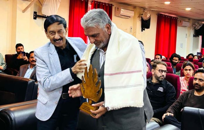 A scholar being honoured during ‘Rajouri Day’ function at BGSBU on Friday. -Excelsior/Imran