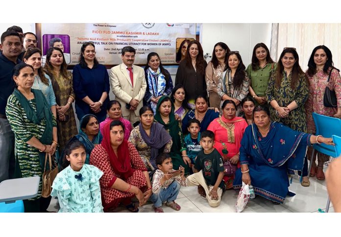 FICCI FLO JKL team and other dignitaries posing with women during a financial literacy event.