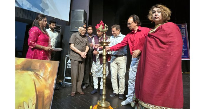 Padma Shri awardees Mohan Singh Slathia and Ramalo Ram lighting the traditional lamp during a function held in Jammu on Sunday.