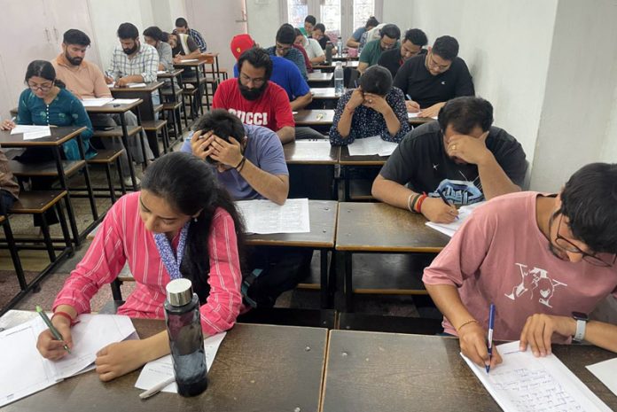 Students busy in solving test series started by SR College in Jammu on Sunday.