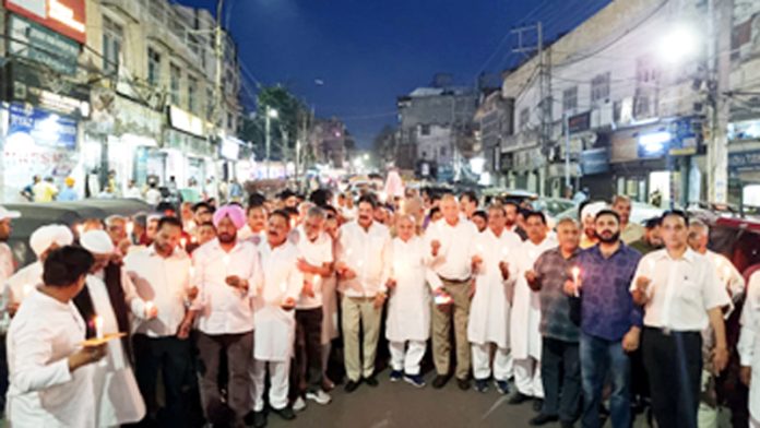 Cong leaders and workers taking out candle-light march in Jammu on Friday evening. —Excelsior/Rakesh