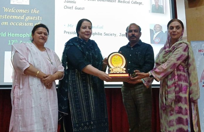 Principal IGGDC, Dr Parveen Akhter Lone along with Rohit Jandial (president, Haemophilia Society Jammu) presenting a memento to Dr Shazia Hamid (Associate Prof, Medicine, GMC Jammu). Principal IGGDC, Dr Parveen Akhter Lone along with Rohit Jandial (president, Haemophilia Society Jammu) presenting a memento to Dr Shazia Hamid (Associate Prof, Medicine, GMC Jammu).