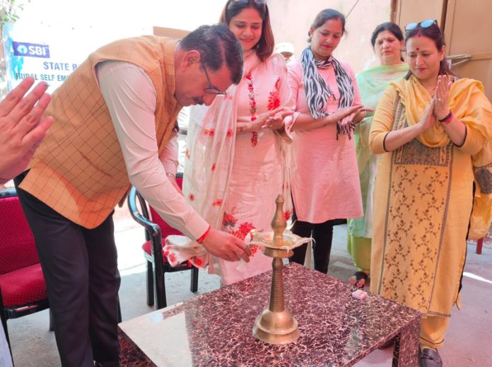 Dharmender Singh, Superintendent of District Jail Amphalla lighting ceremonial lamp to inaugurate training programme in tailoring for jailed women.
