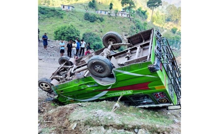 A bus over turns in Manjakote area of Rajouri on Tuesday. -Excelsior/Imran