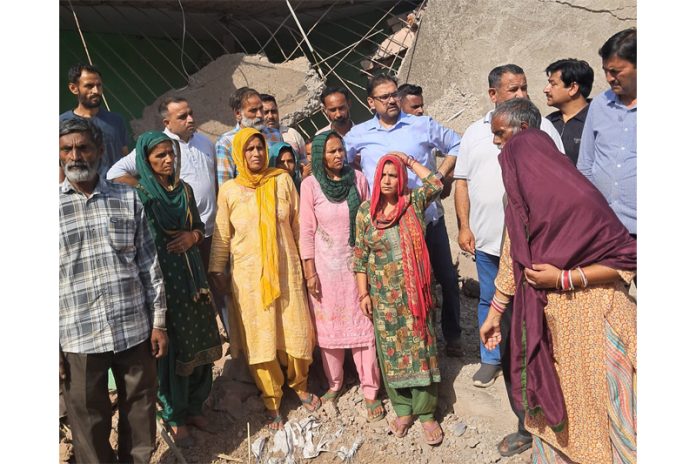 Minister Satish Sharma visiting shelling affected village on Tuesday.
