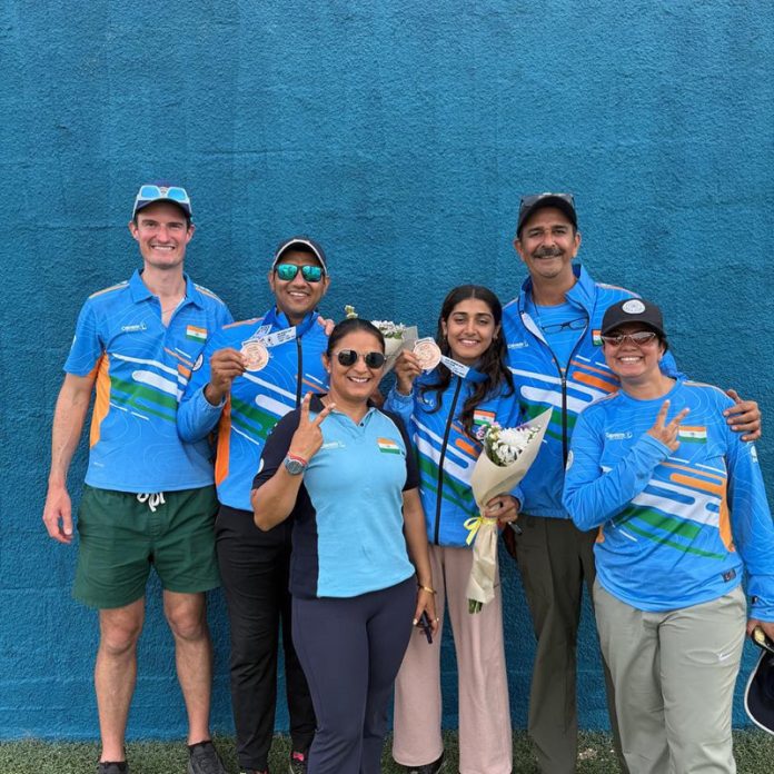 A jubilant Kynan Chenai & Sabeera Haris (4th from left) with coaches & support staff after winning bronze at Trap Mixed Team event in Nicosia. A jubilant Kynan Chenai & Sabeera Haris (4th from left) with coaches & support staff after winning bronze at Trap Mixed Team event in Nicosia.
