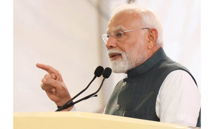 Prime Minister Narendra Modi addressing the gathering in Alipurduar, West Bengal on Thursday. (UNI)