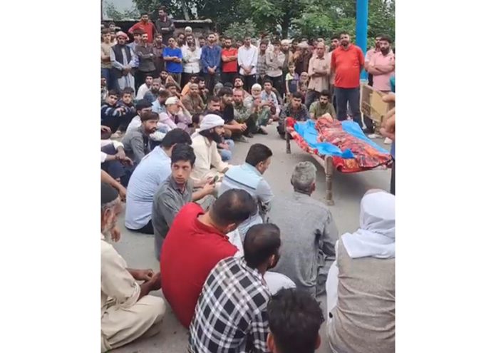 Keeping dead body on road, villagers staging protest in Budhal area on Saturday. -Excelsior/Imran