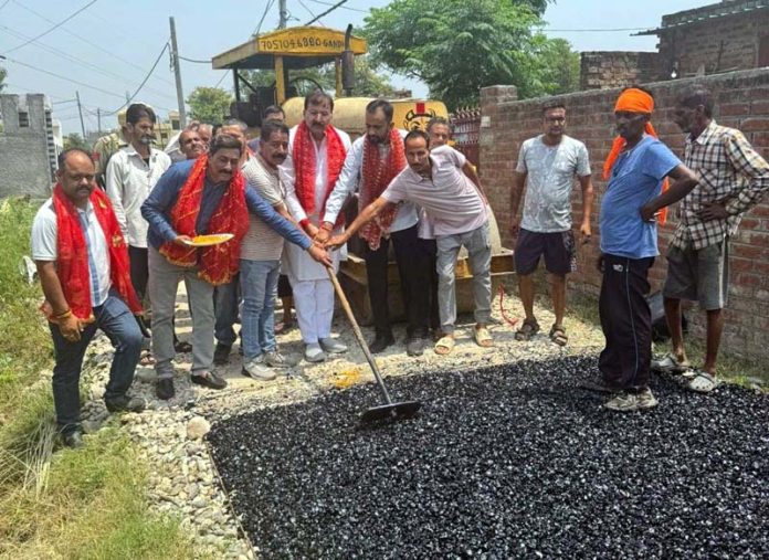 MLA Arvind Gupta starting road black-topping work in Trilokpur on Wednesday.