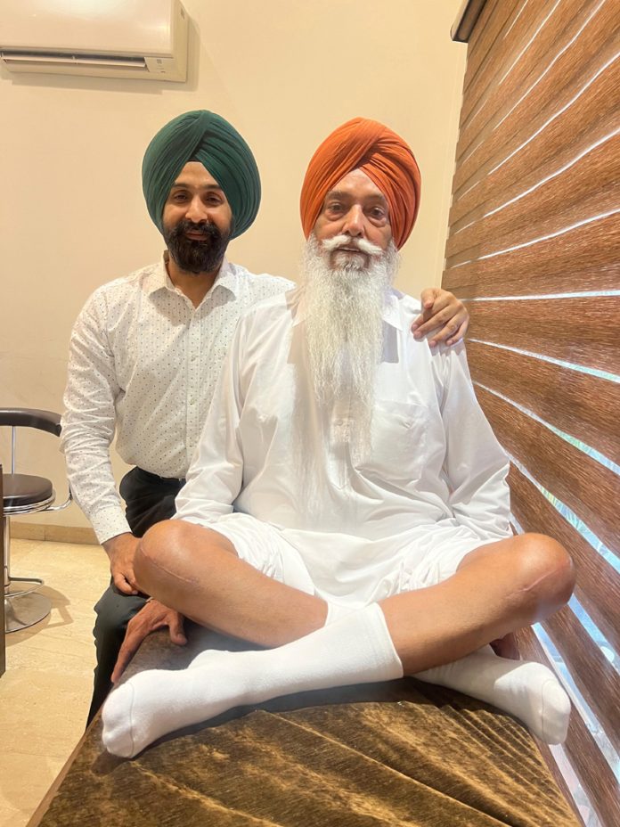 Dr Ranjit Singh posing with a patient on whom he performed bilateral knee replacement surgery.