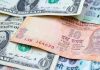 Rupee slumps 84 paise to close  at 85.61 against US dollar
