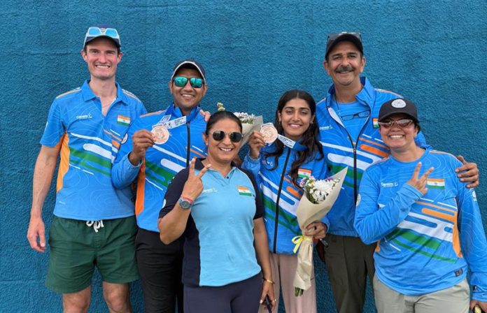 A jubilant Kynan Chenai & Sabeera Haris (4th from left) with coaches & support staff after winning bronze at Trap Mixed Team event in Nicosia.