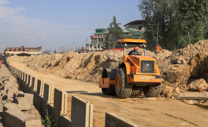 A transmission line is seen over the under-construction Sanat Nagar flyover in Srinagar, causing delays in its completion. — Excelsior/Shakeel