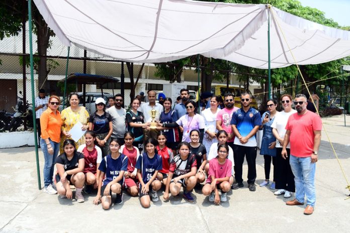 Players posing with dignitaries for group photograph.