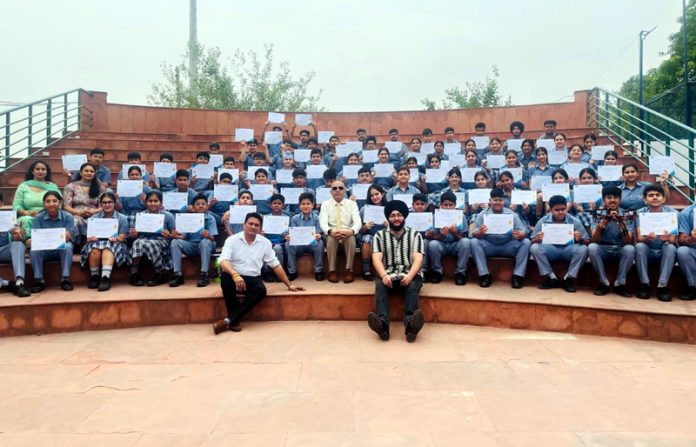 Students posing along with certificates.