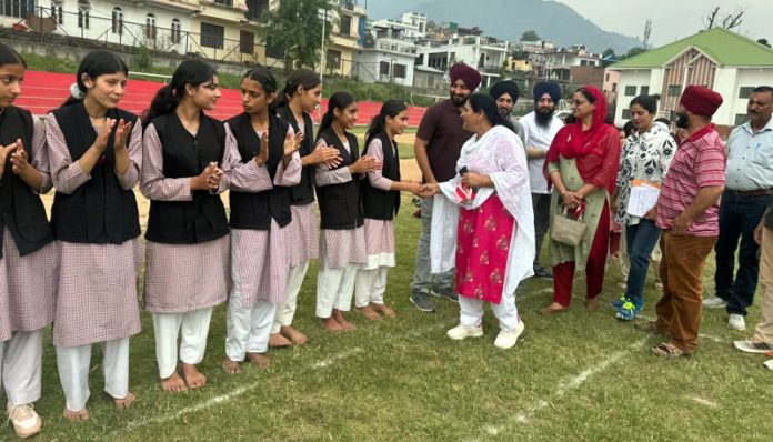 Dignitary interacting with girl's team before match at Poonch.