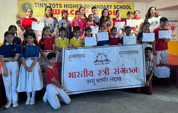 Dignitaries posing along with students during a programme.