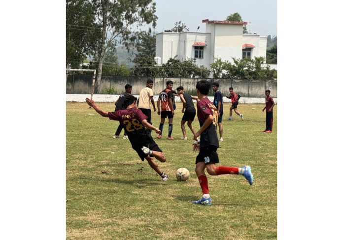 Football players in action during a match at Rajouri.