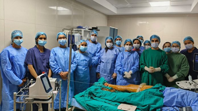 A team of doctors posing after performing a procedure on a patient at AIIMS Jammu.