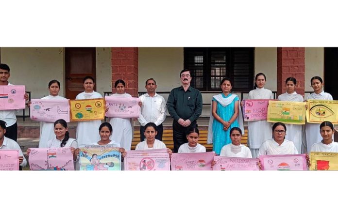 Students posing along with posters during a programme.