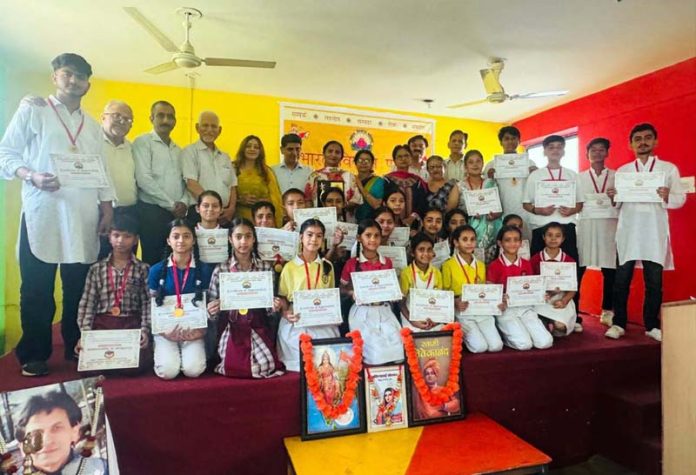 Students posing with certificates alongside dignitaries during a programme.