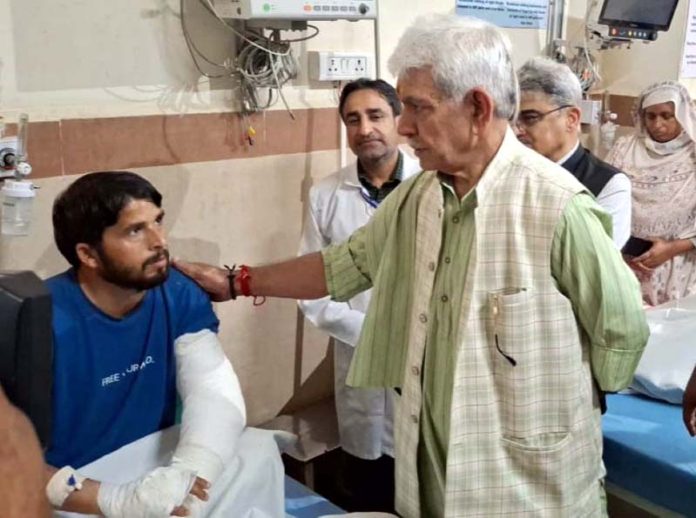 LG Manoj Sinha meeting with a victim at GMC Rajouri on Wednesday.