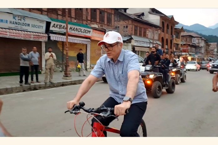 Chief Minister Omar Abdullah cycling in Pahalgam market after Cabinet meeting on Tuesday. -Excelsior/Sajad Dar Chief Minister Omar Abdullah cycling in Pahalgam market after Cabinet meeting on Tuesday. -Excelsior/Sajad Dar